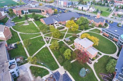 An aerial view of a college campus in Northeast Indiana with interconnected footpaths and large trees.